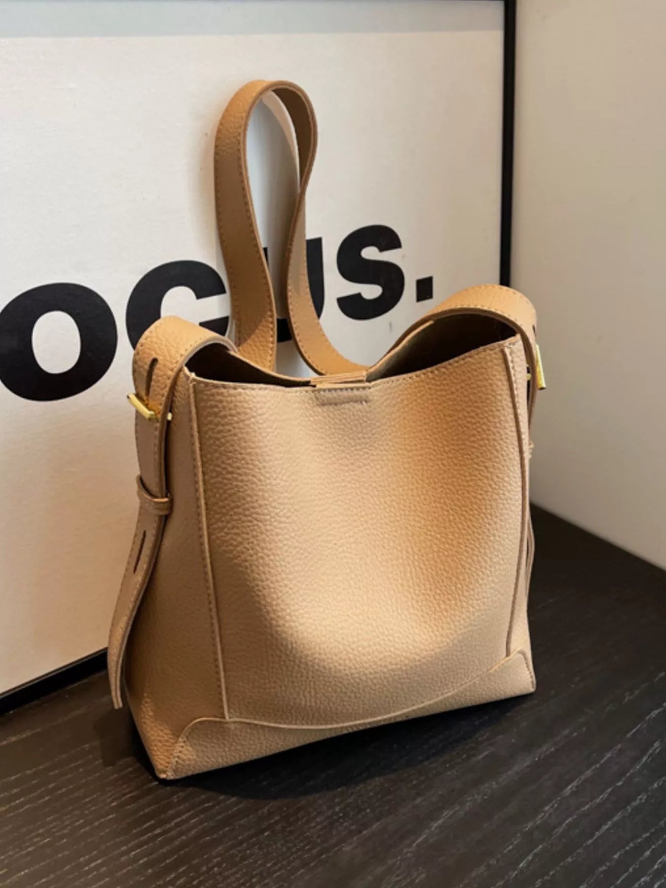 Khaki leather crossbody bag with adjustable strap and zip-top front
