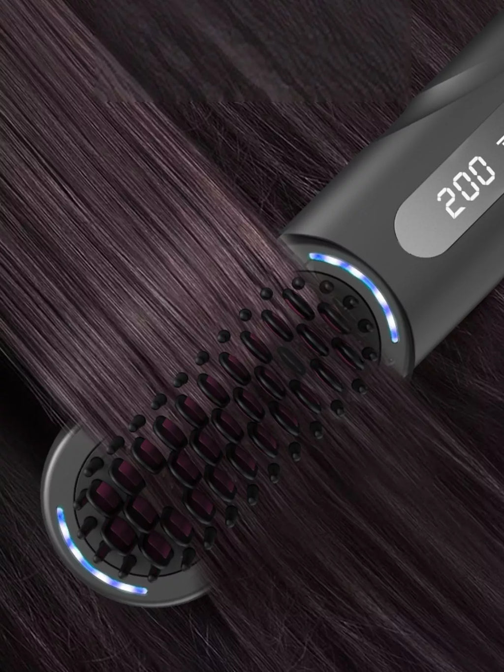 Heated straightening comb on hair strands; blue edge lights along the brush