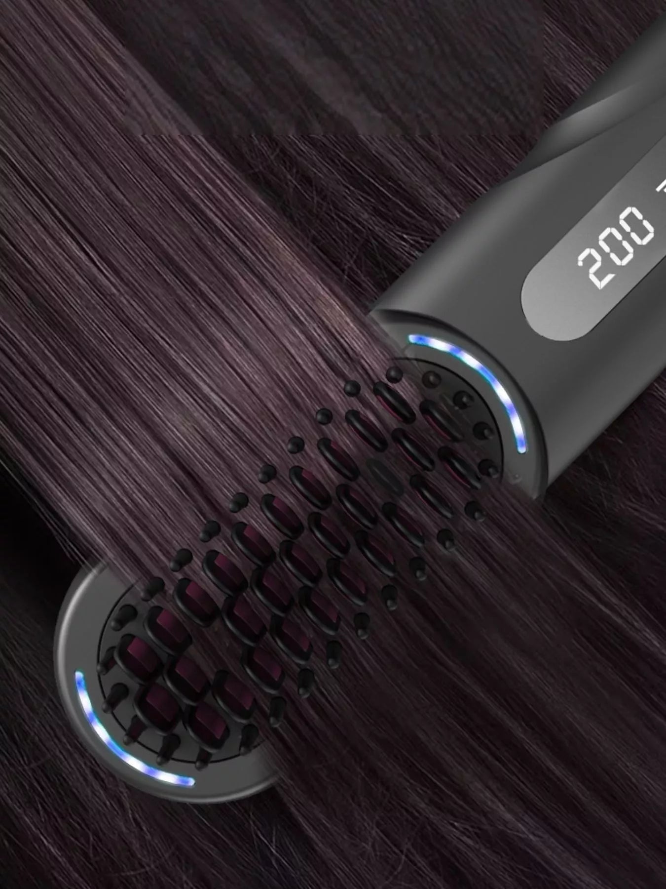 Heated straightening comb on hair strands; blue edge lights along the brush