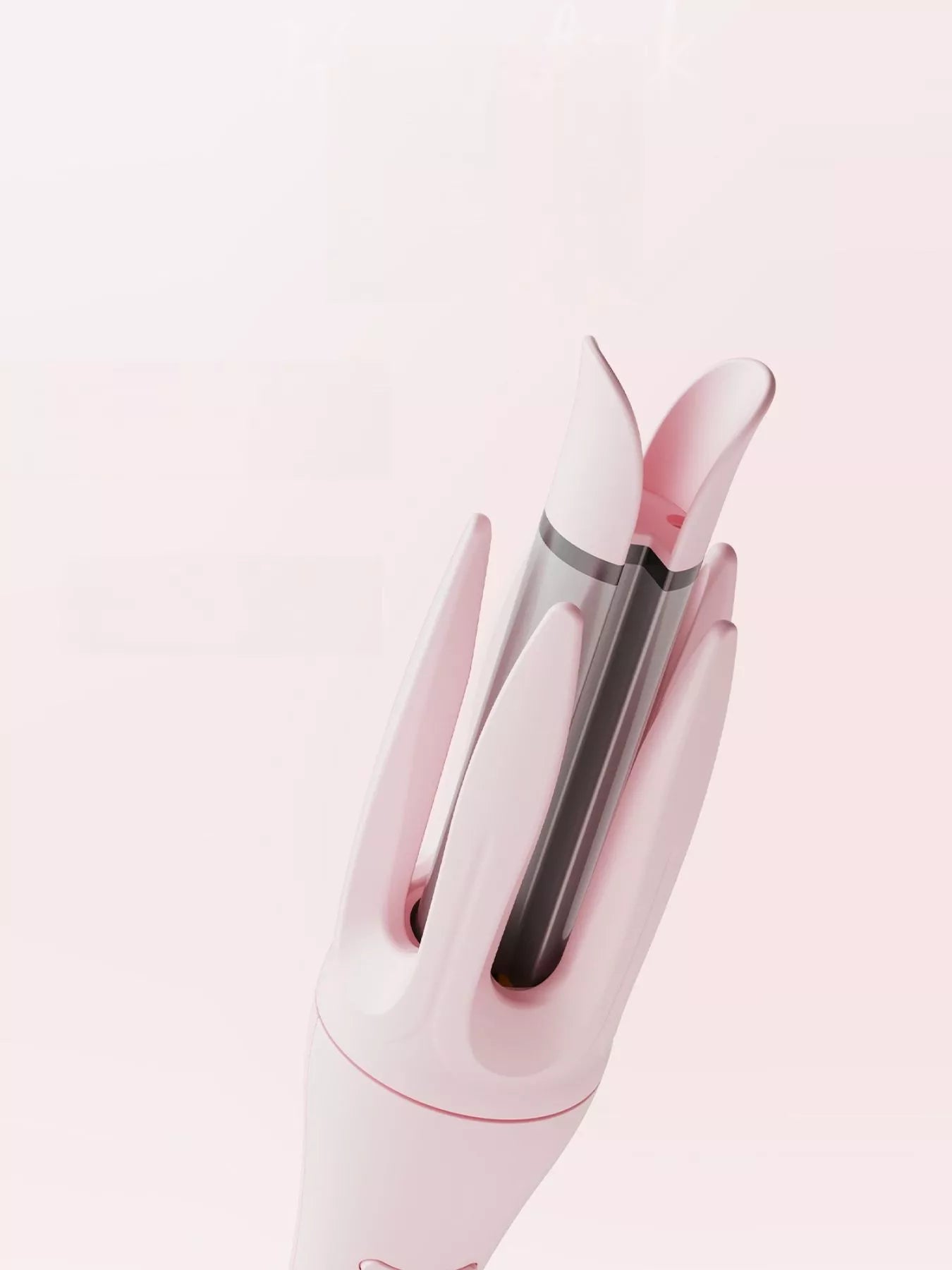 Blush Pink rotating ceramic curling iron, angled view of ceramic barrel opening