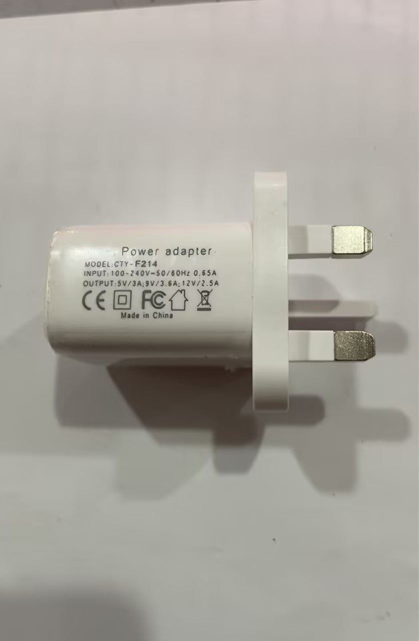 White power adapter with two-pin plug, wall-plug prongs and adapter label visible.