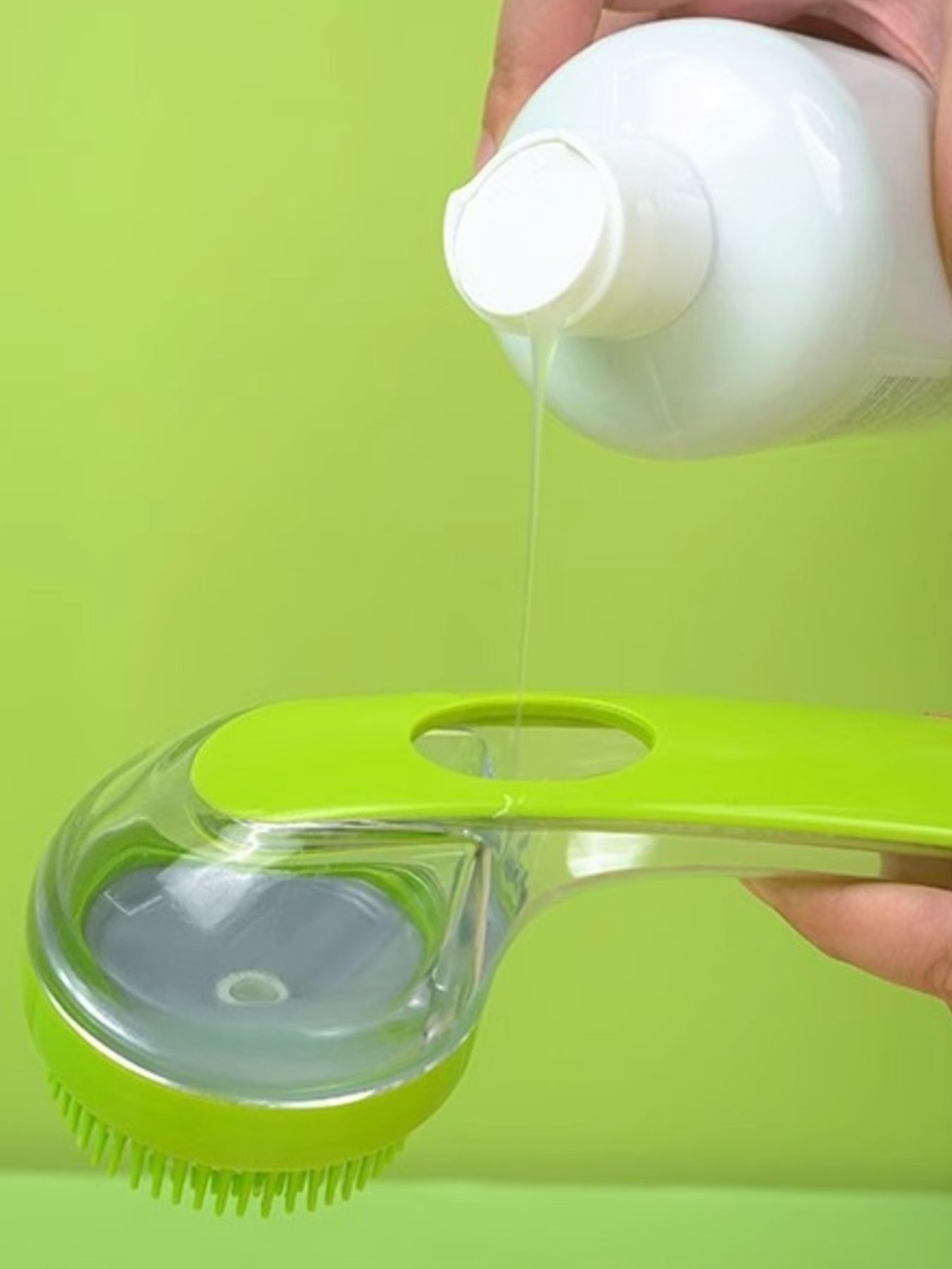 Lime green Soft Pet Shower Brush filling with water from a squeeze bottle