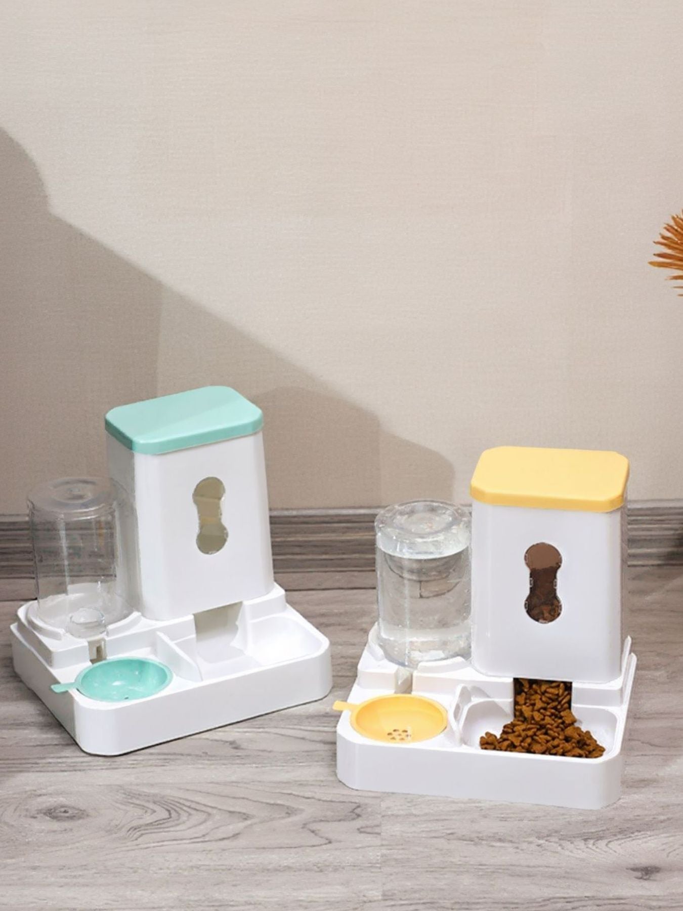 Pet dispenser base with mint and yellow lids, water cups and food compartments.