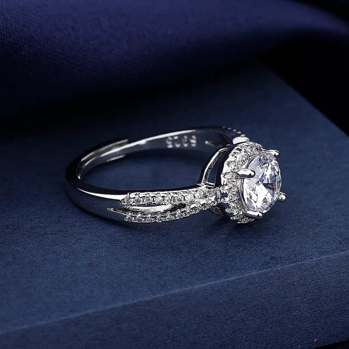925 sterling silver ring with round moissanite and split pavé band, side view