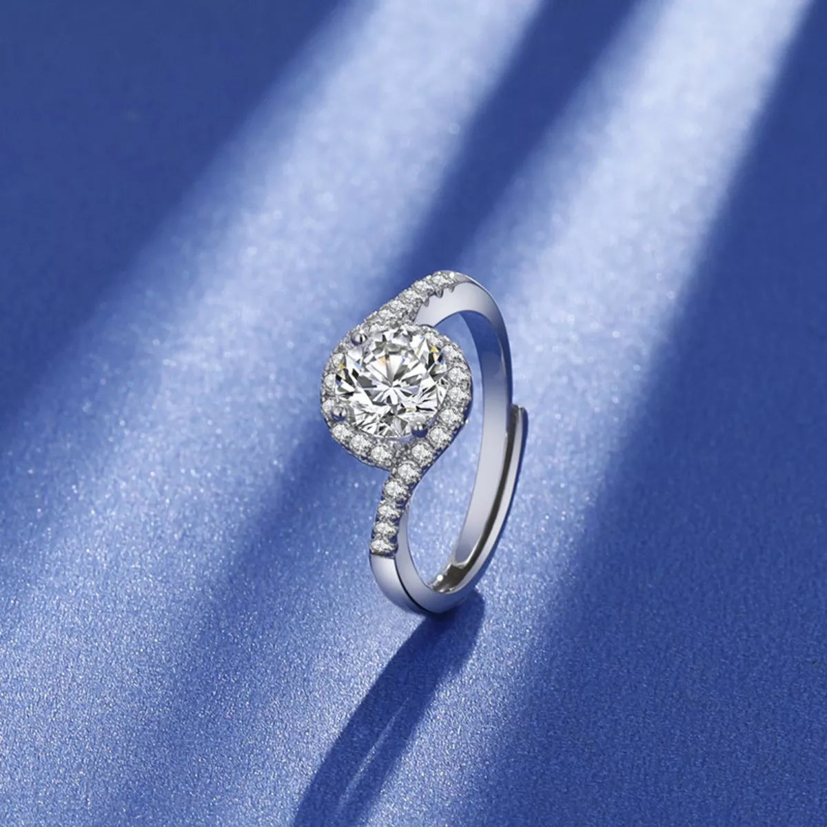 Side view: silver moissanite ring with round halo center and pavé band