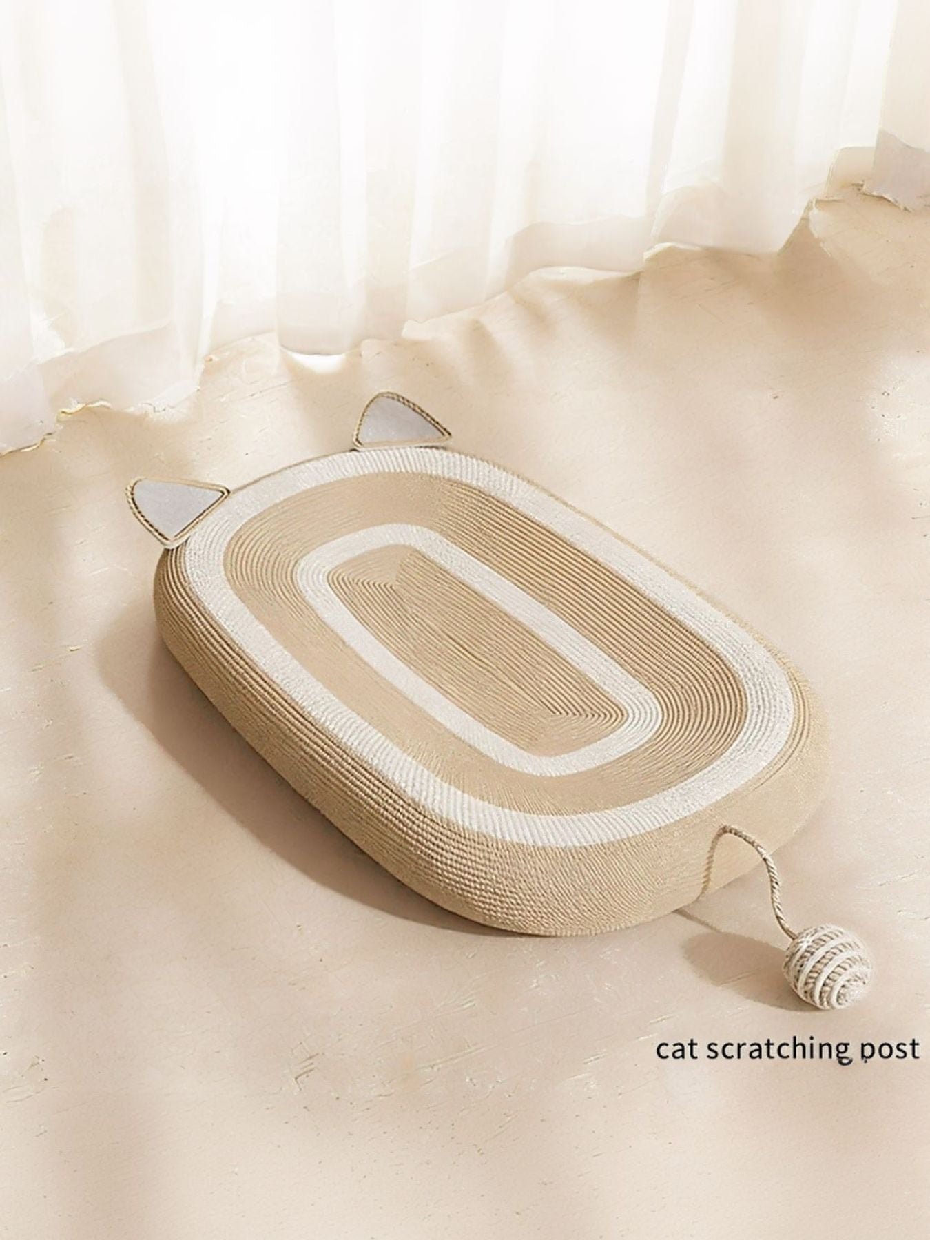 Beige oval scratching bed with white stripe pattern and rope toy at both ends