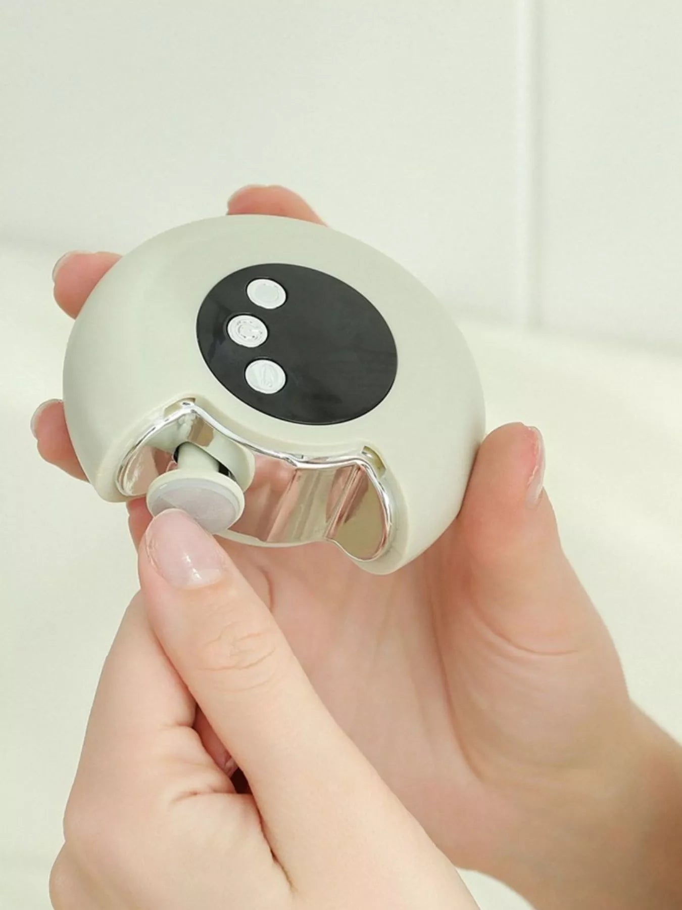 Portable electric nail buffer polisher in white, close-up of metal grinding head