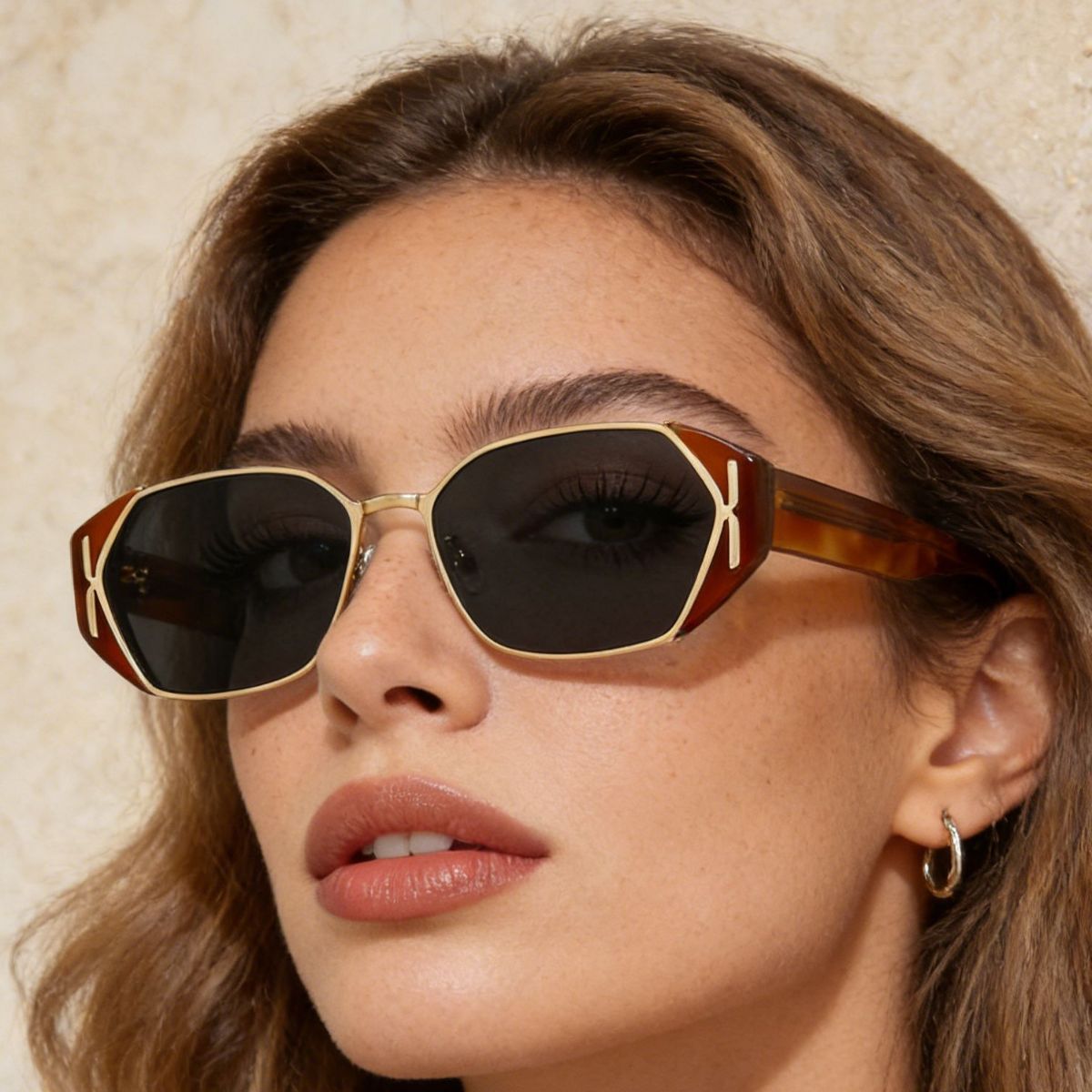 Terracotta geometric UV sunglasses, side view with gold frame and dark lenses.