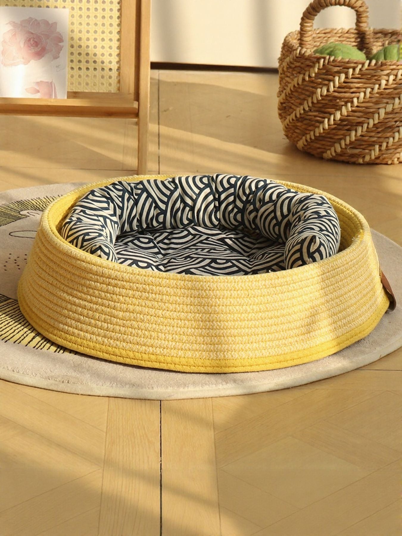 Woven rattan pet nest with yellow woven base and zebra-pattern inner cushion